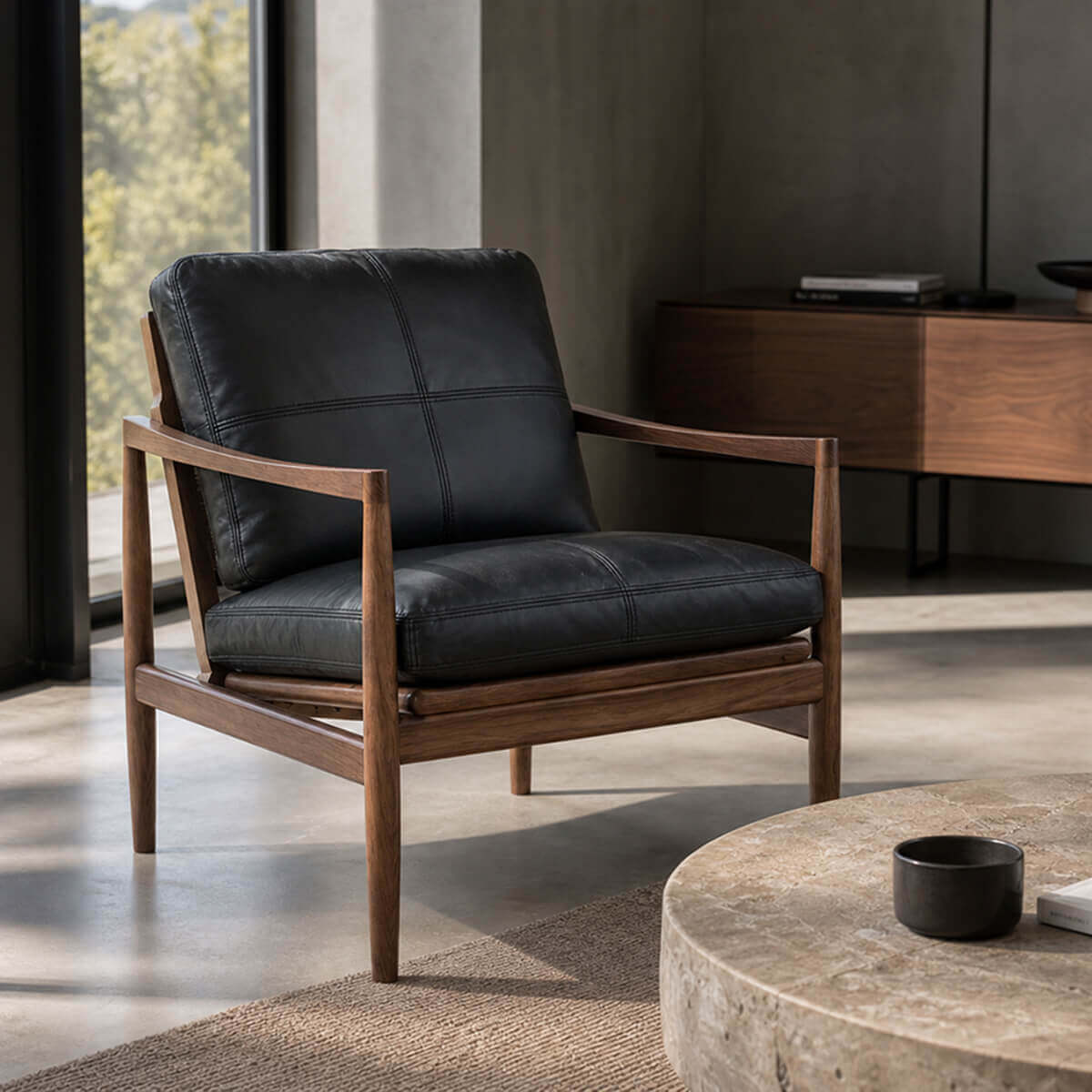 Hank armchair with black leather upholstery in a contemporary living room