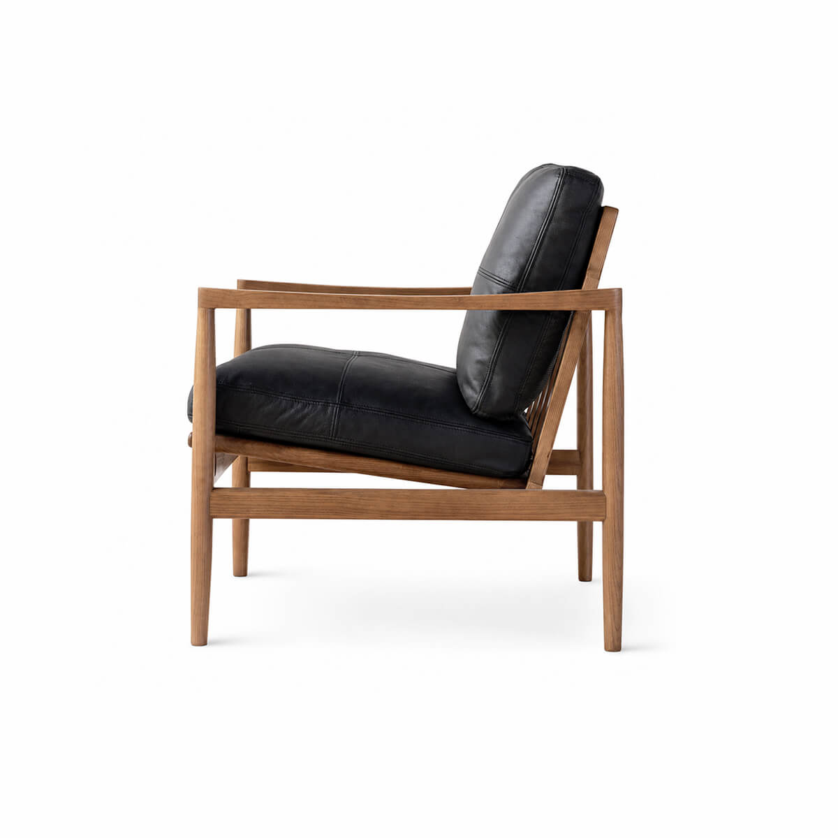 Side view of Hank armchair with black leather upholstery