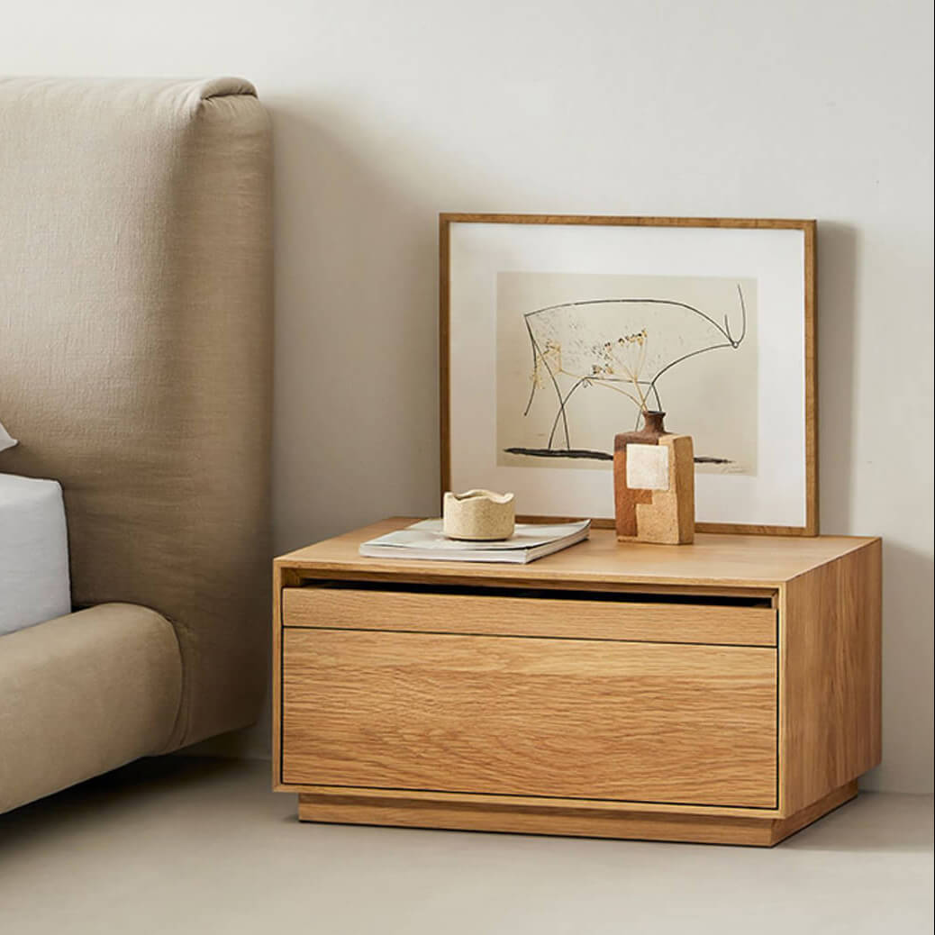 Heidelberg oak bedside table beside upholstered bed