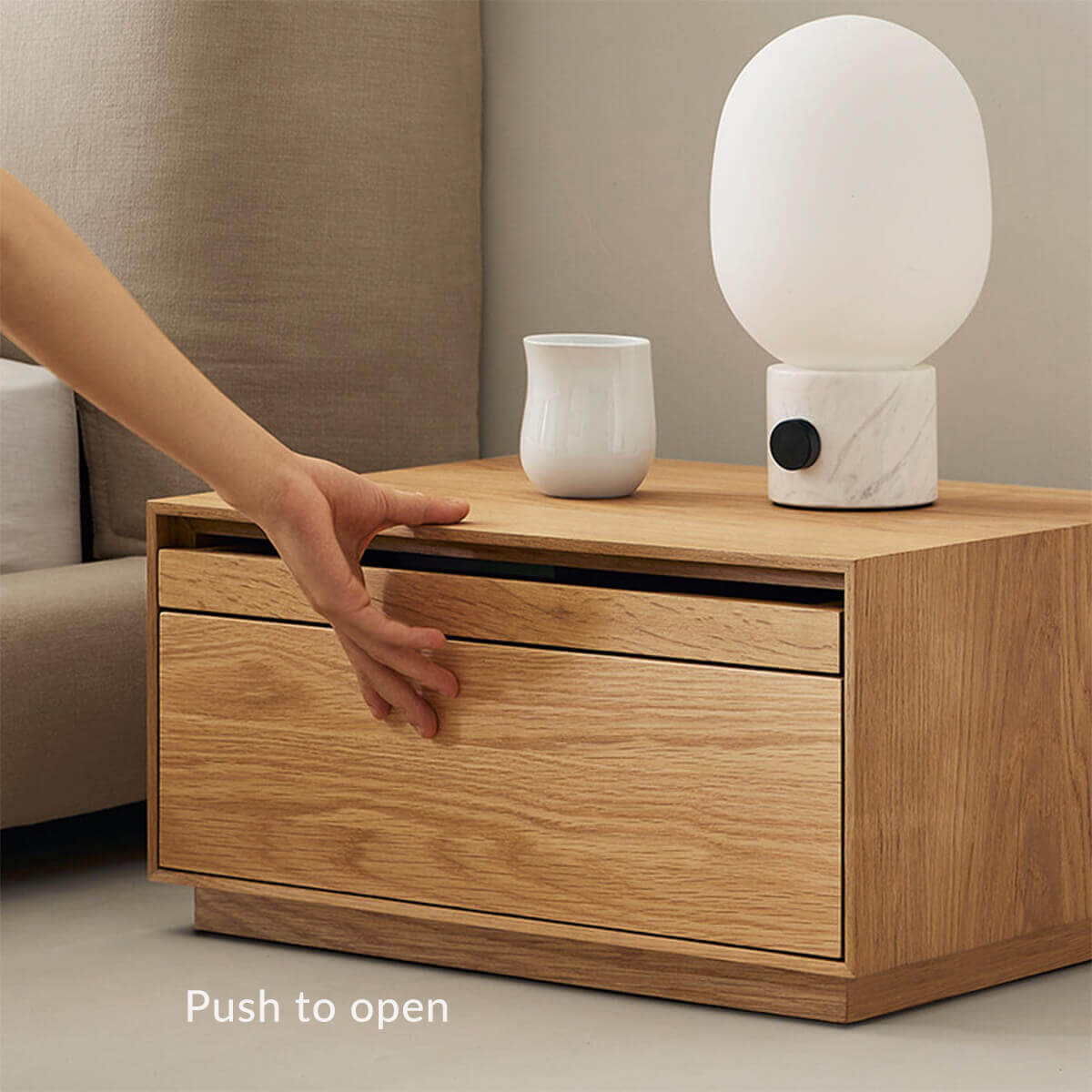 Push-to-open drawer of Heidelberg bedside table