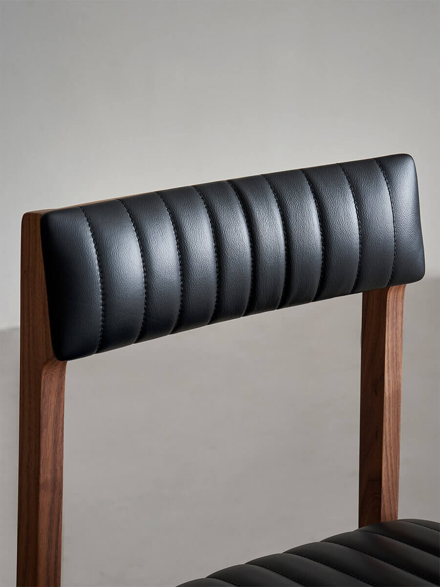 Jackson dining chair with channel-stitched black leather backrest