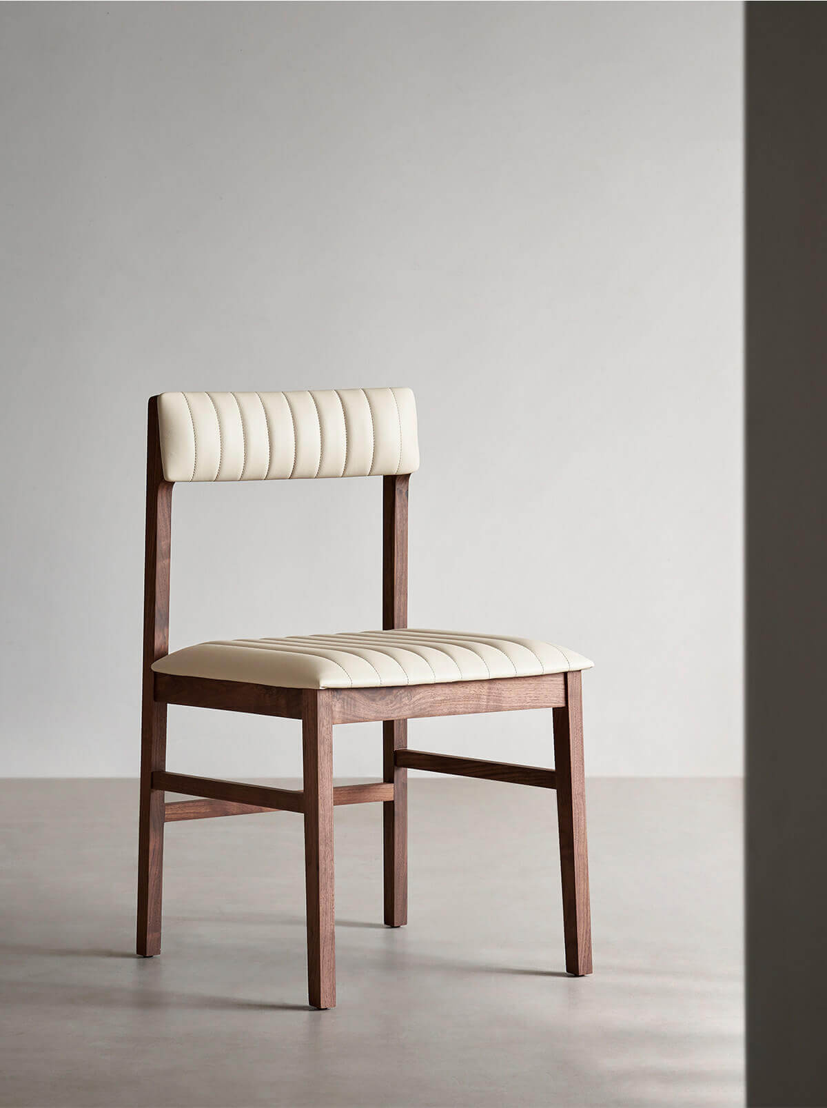 Jackson solid walnut dining chair with off-white leather upholstery