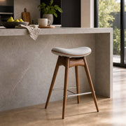 Jackson walnut bar stool beside a modern kitchen island