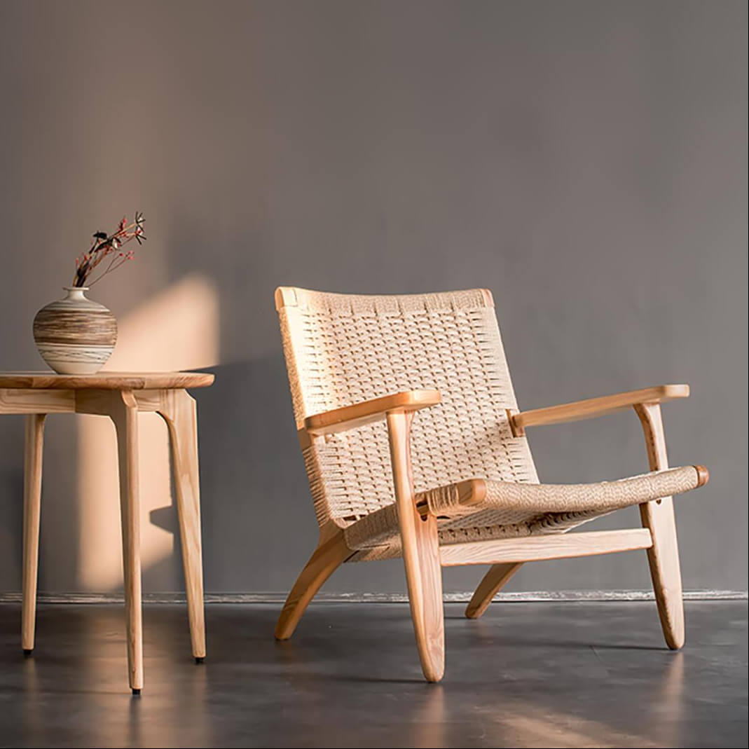 Kelaos armchair featuring a solid ash wood frame and handwoven rope construction