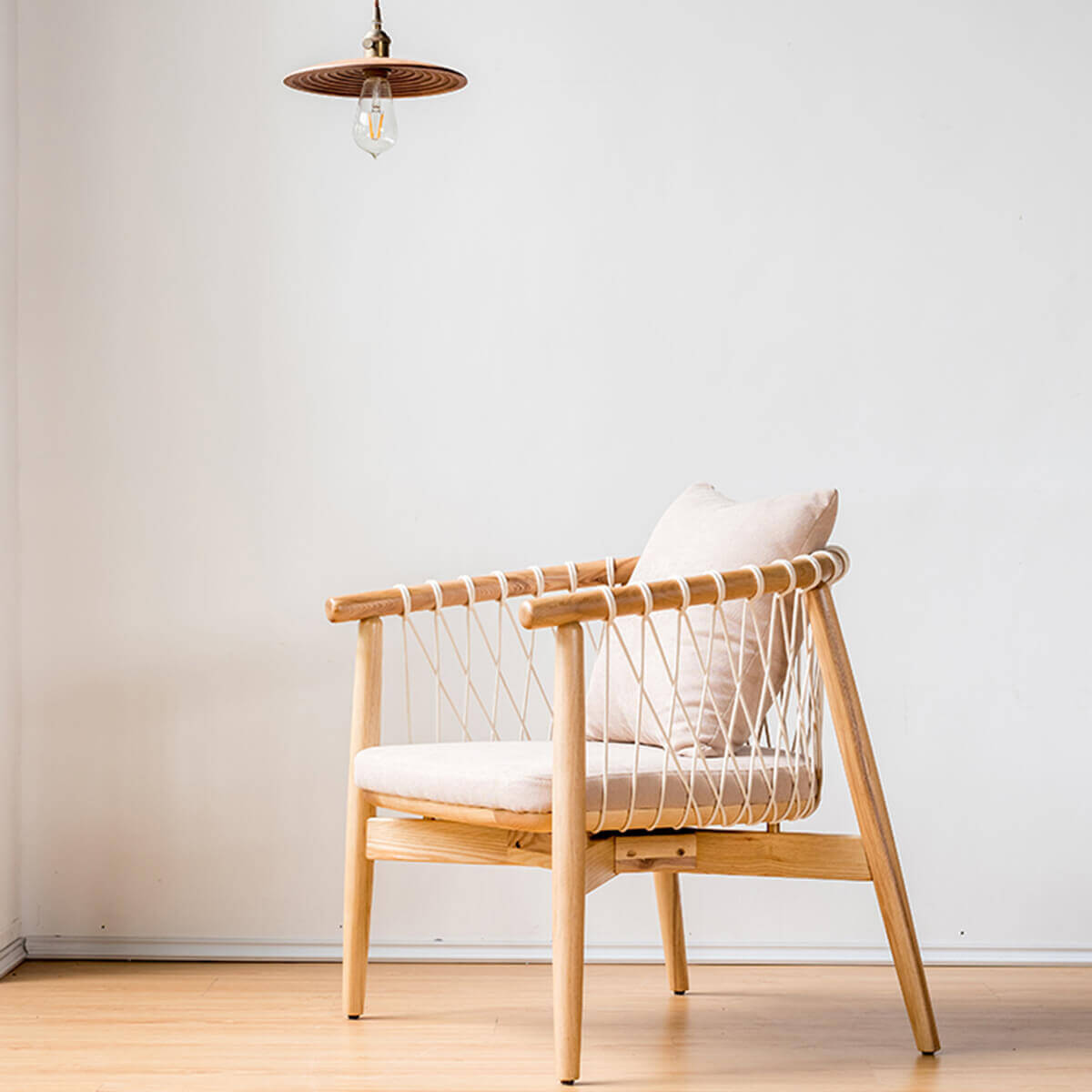 Kniss woven armchair in natural ash finish with woven backrest