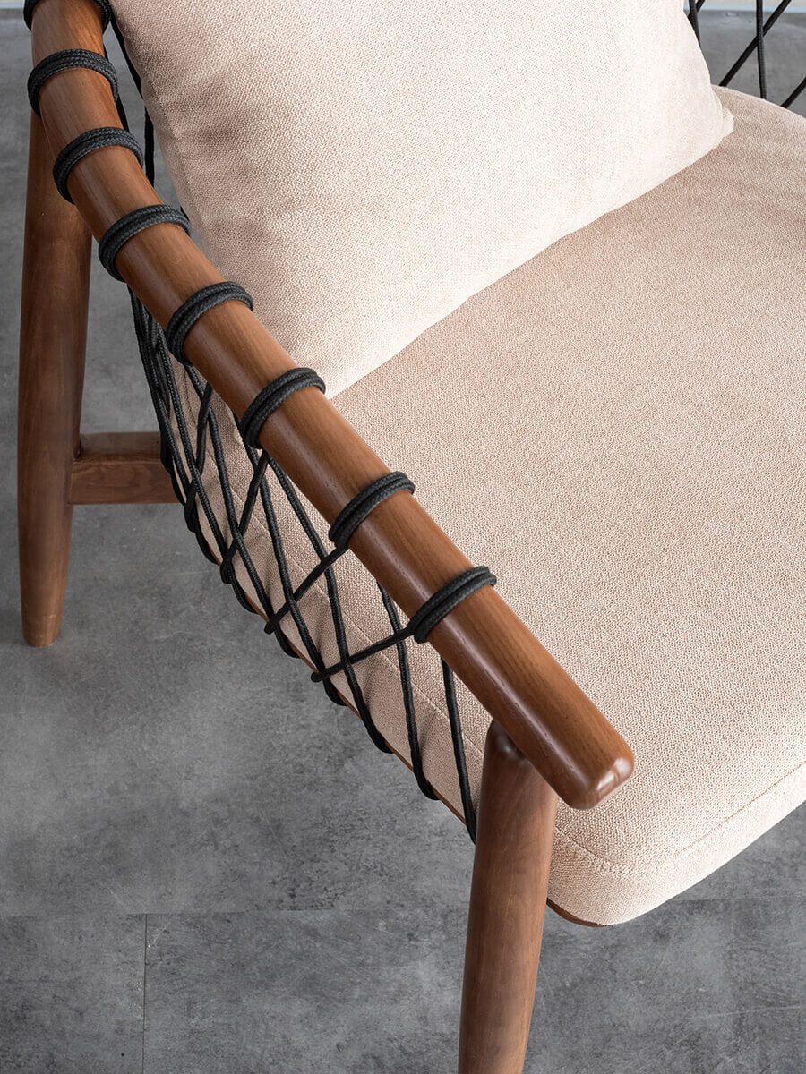 Close-up of the Kniss armchair woven backrest and solid ash frame