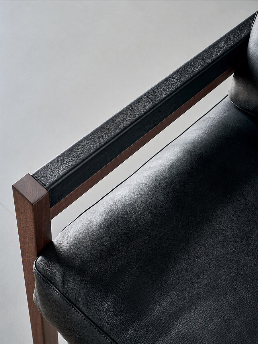 Leather-wrapped armrest detail of Lars Solid Walnut Armchair