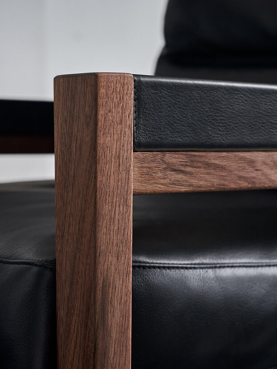 Solid black walnut frame and leather upholstery detail on Lars Armchair