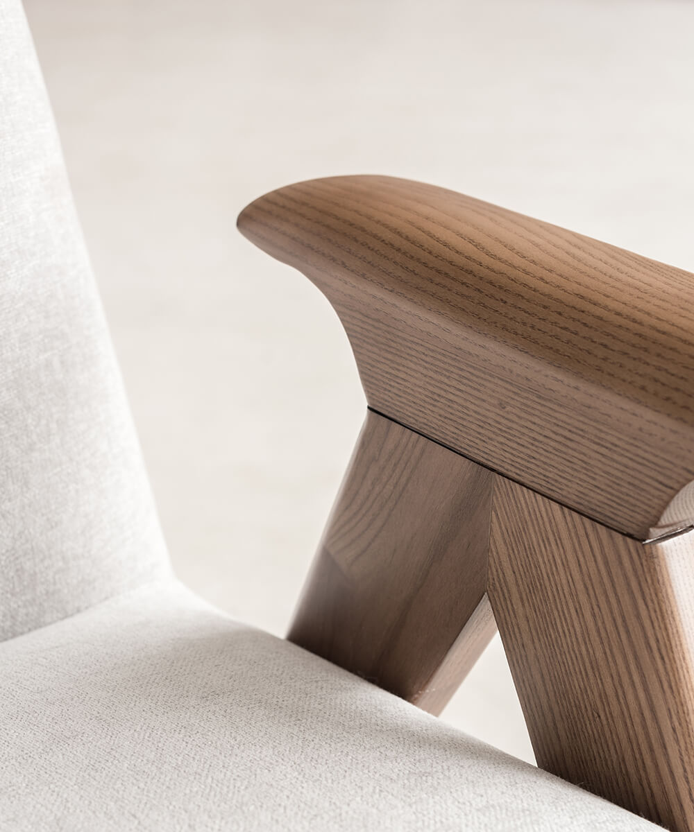 Curved timber armrest detail of Libera armchair replica