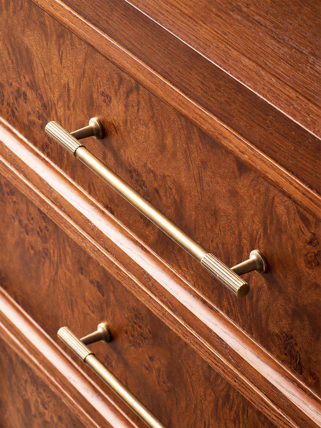 Antique brass-tone handle on Louvre burl wood chest of drawers