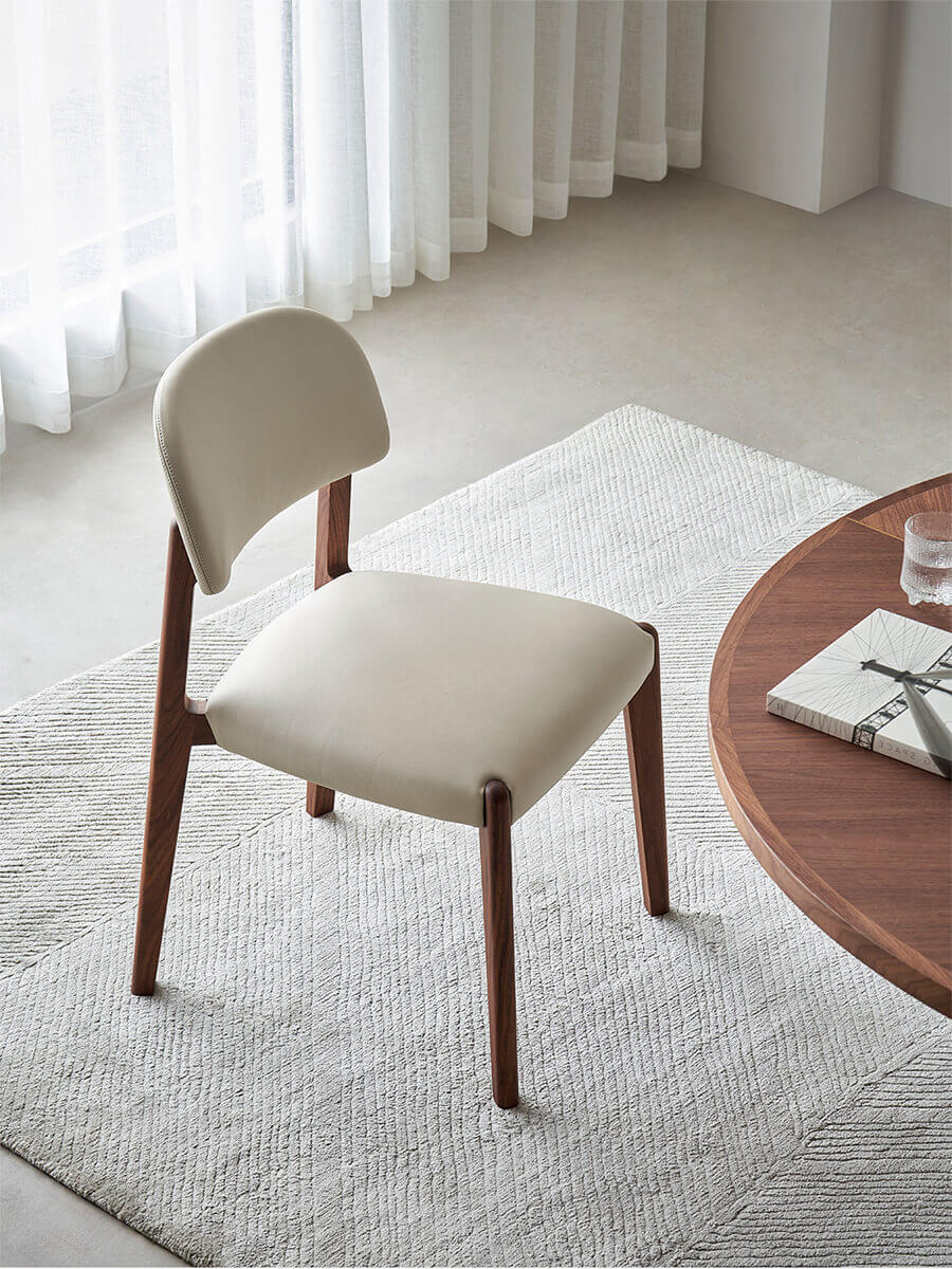 Malo top-grain leather dining chair with sculpted solid walnut frame