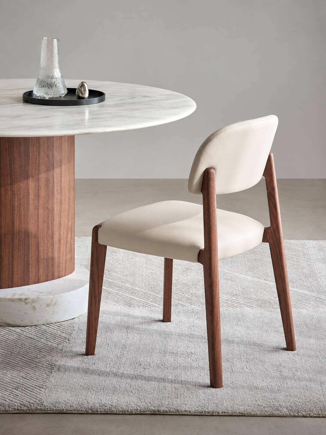 Side view of Malo solid walnut and leather dining chair