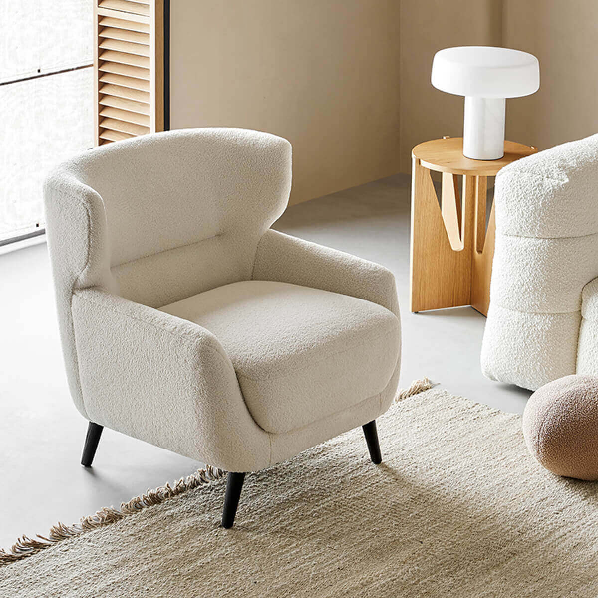 Mandy bouclé fabric armchair with high back design in a contemporary living room