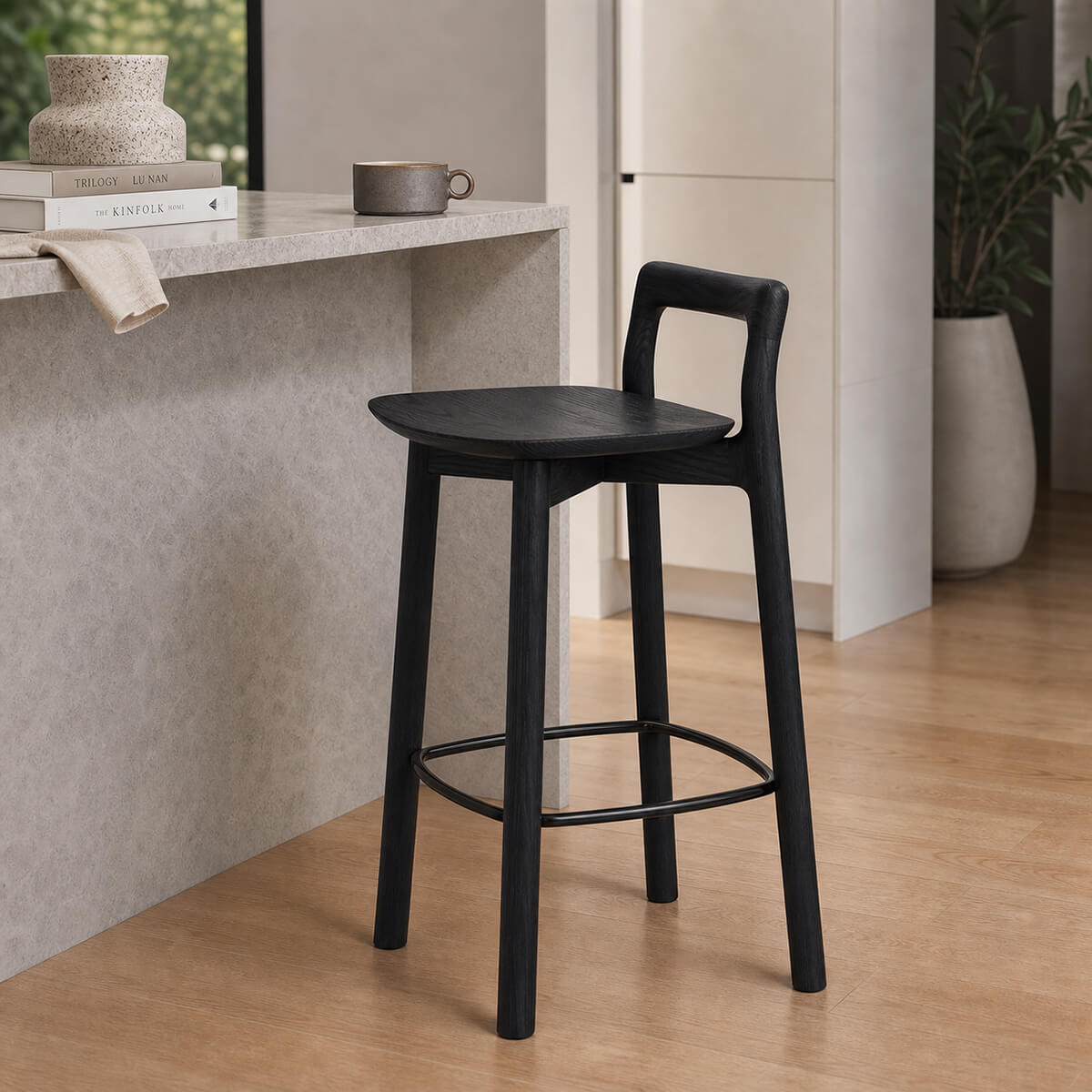 Mountain timber bar stool in black finish beside a kitchen island