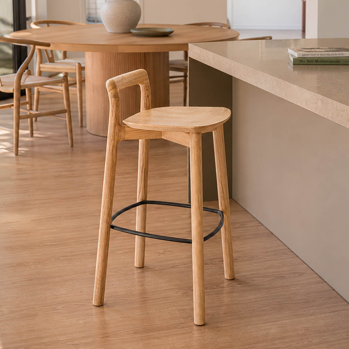 Mountain timber bar stool beside a modern kitchen island
