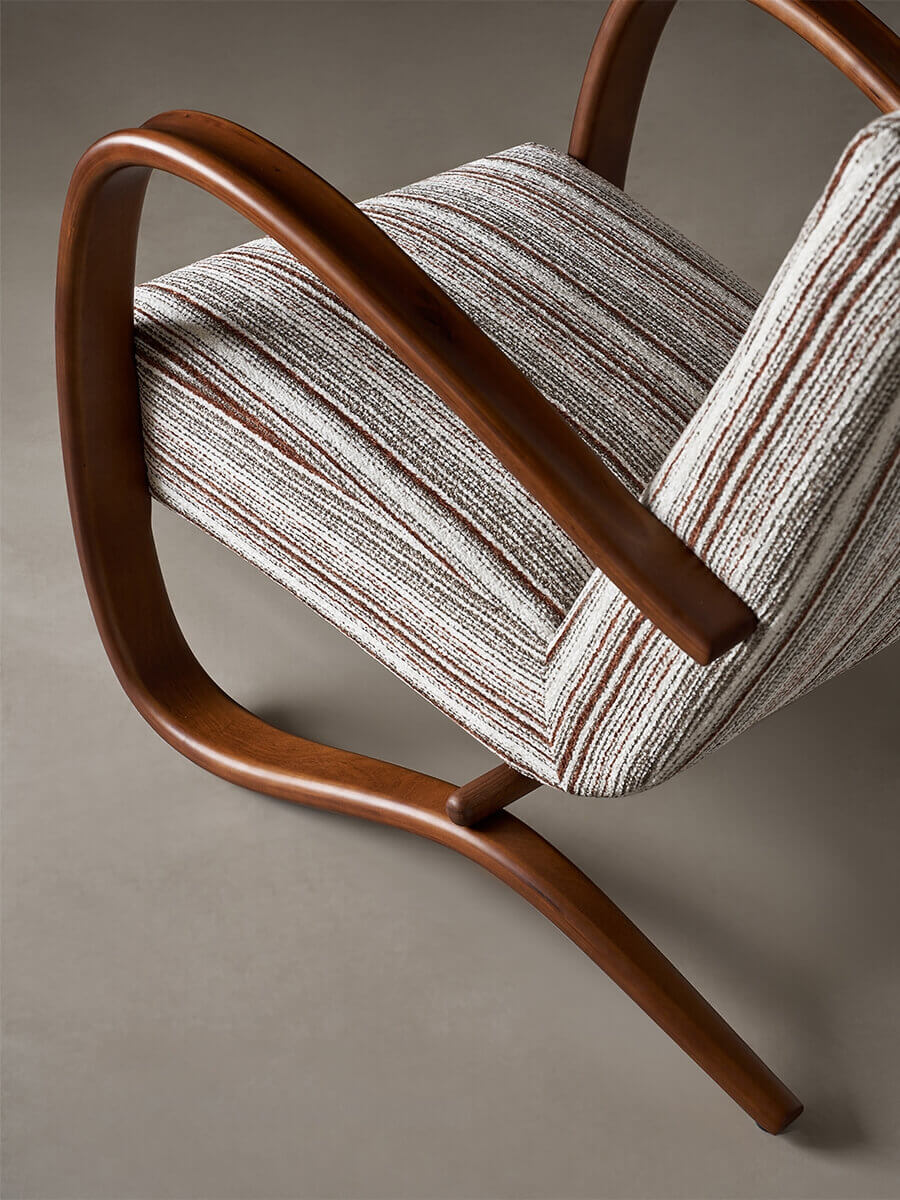 Curved timber armrest detail of Neva armchair
