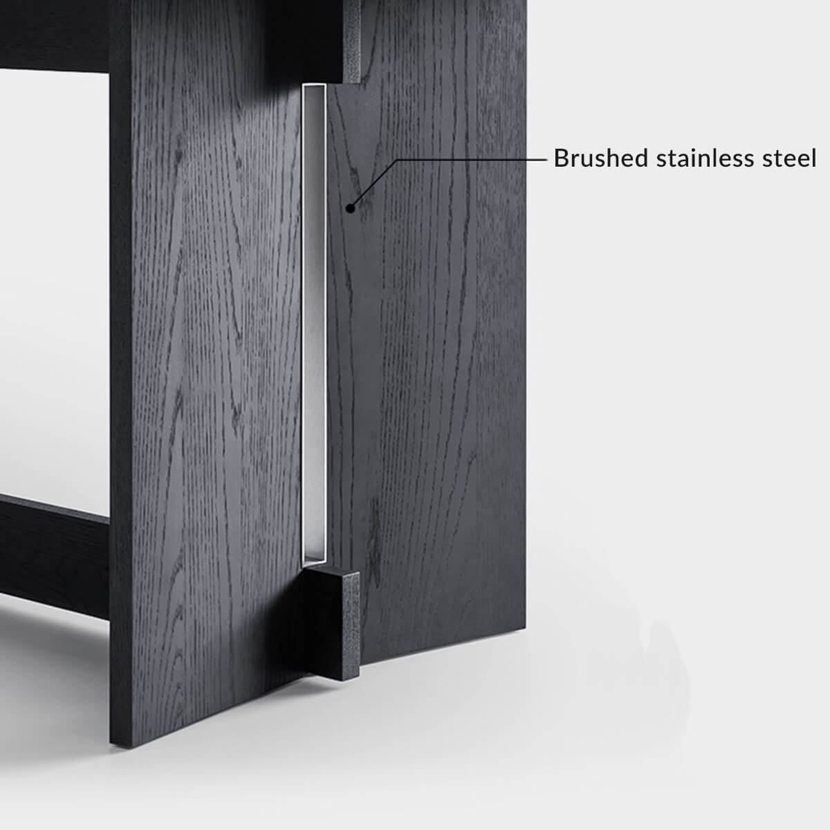 Brushed stainless steel detail on the Noir Dining Table base