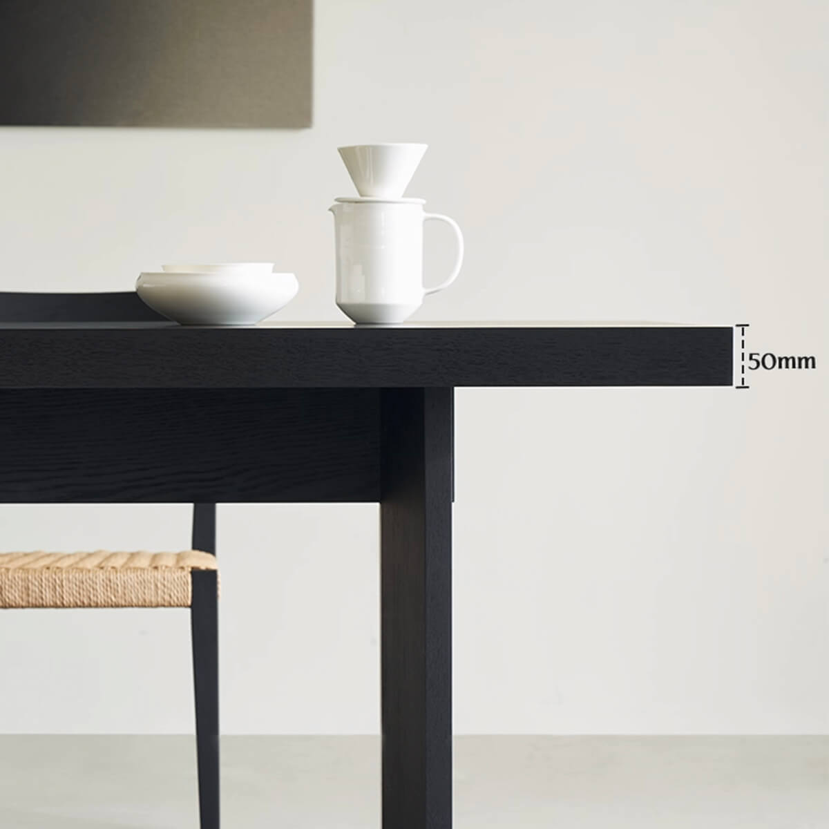 Thick tabletop profile of the Noir Dining Table