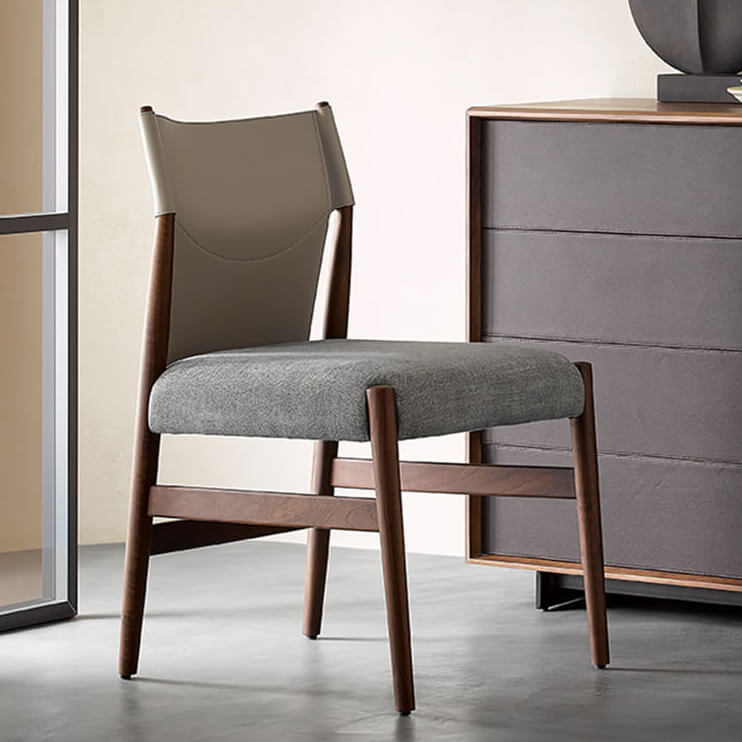 Nora dining chair with saddle leather backrest and grey upholstered seat beside timber furniture