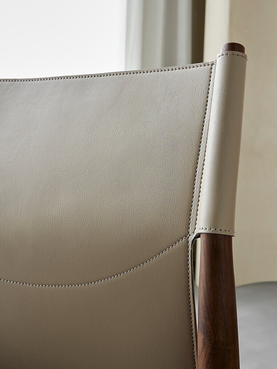 Close-up detail of saddle leather backrest on Nora dining chair