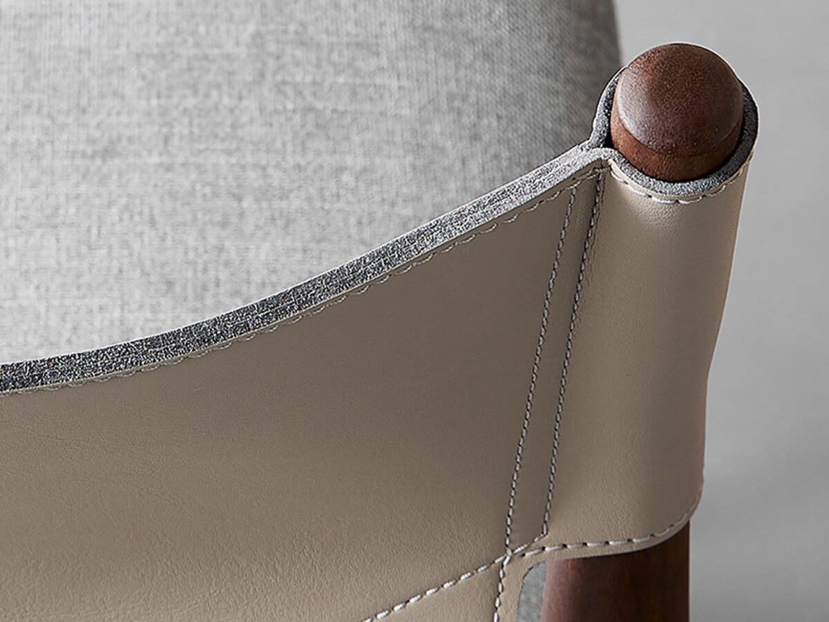 Close-up detail showing stitching and saddle leather finish on Nora dining chair