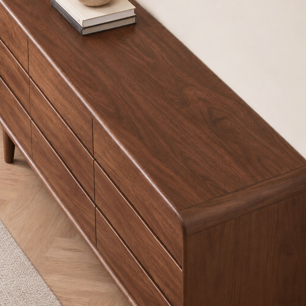 Close-up of natural solid walnut wood grain and rounded cabinet edges on the Norwich dresser