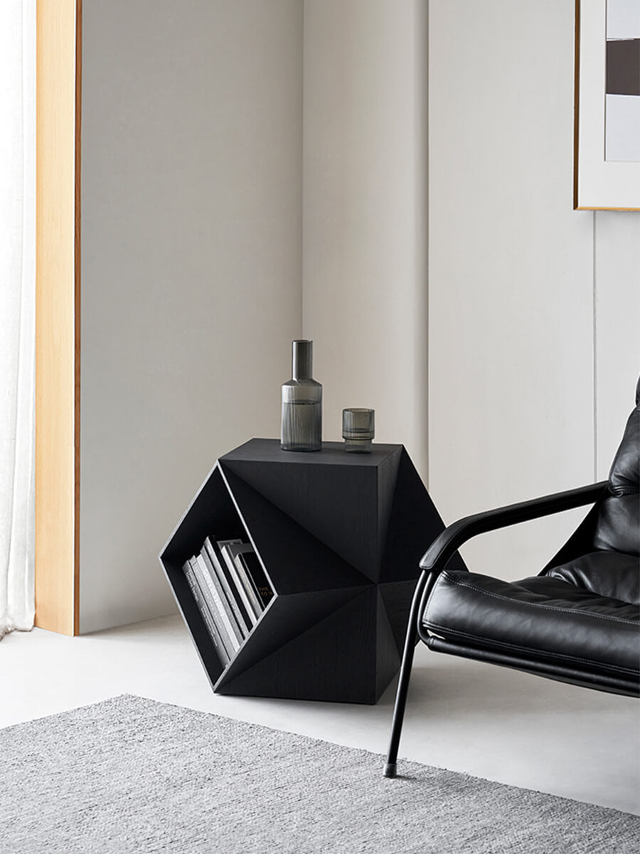 Prism Sculptural Side Table in black finish styled as a reading corner side table
