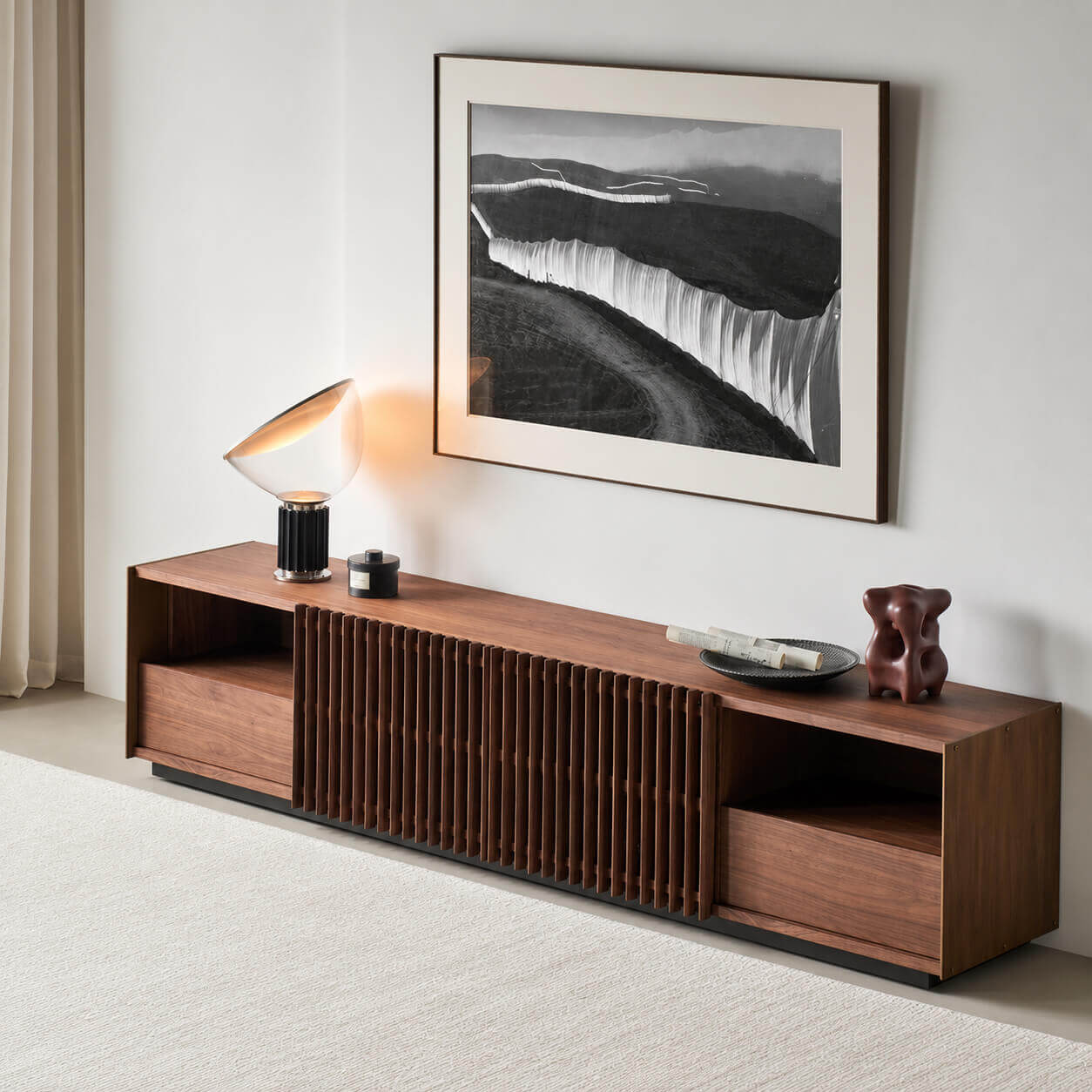 Angled view of the Rhythm Walnut TV Unit with solid walnut slatted sliding doors
