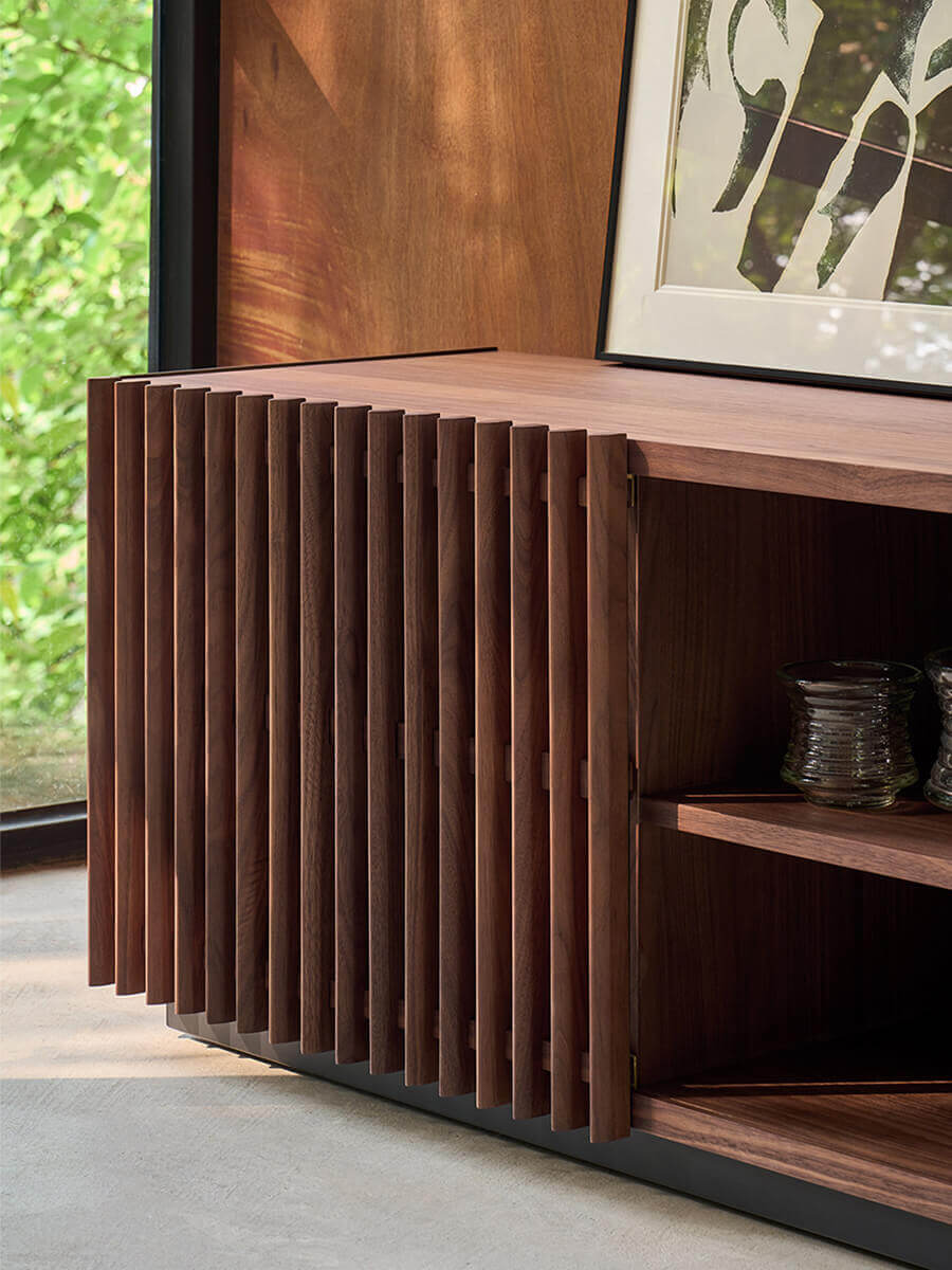 Close-up of the solid walnut slatted sliding door design