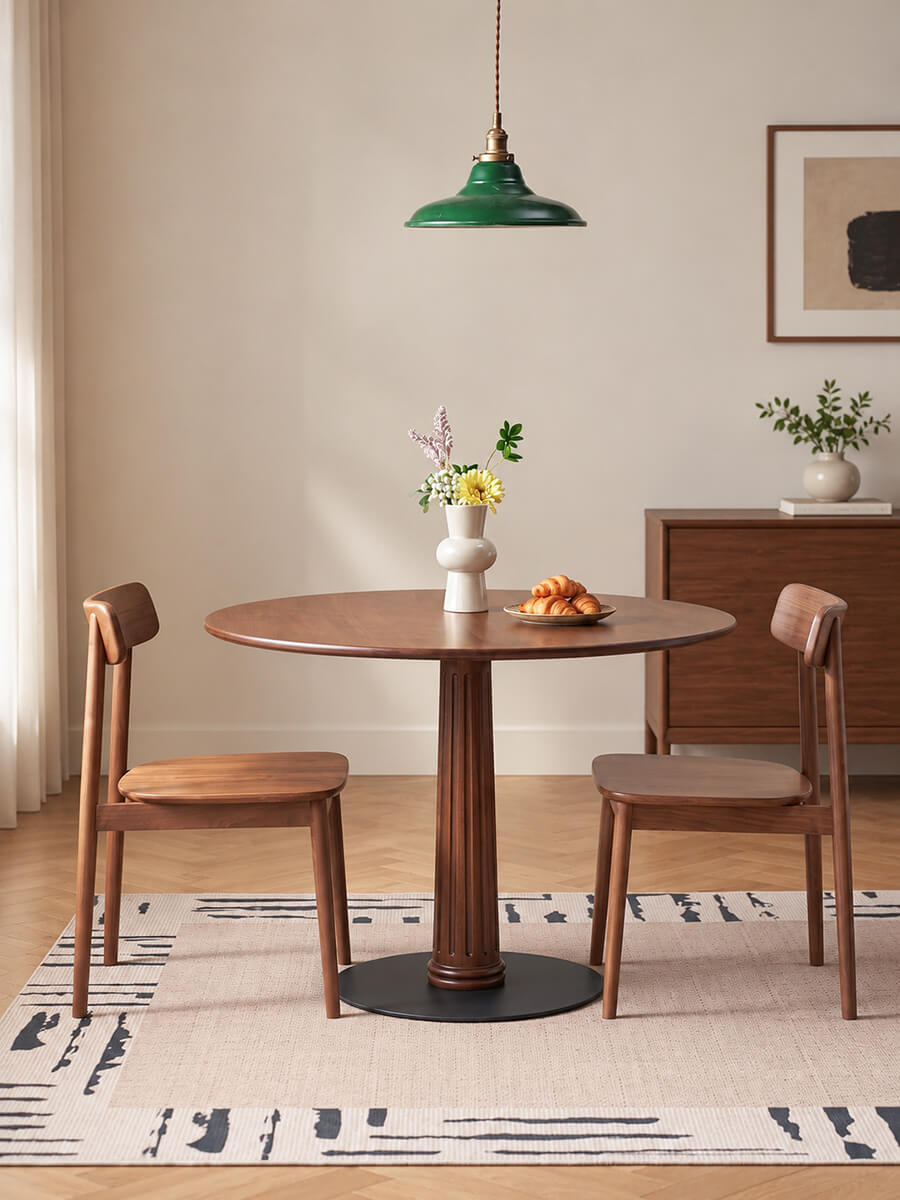 Riva Solid Walnut Round Dining Table in a modern dining room with walnut chairs