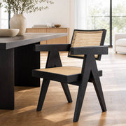 Sandy dining chair with black ash wood frame and woven rattan seat