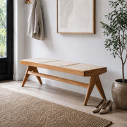 Sandy solid timber bench with natural rattan seat in a modern entryway