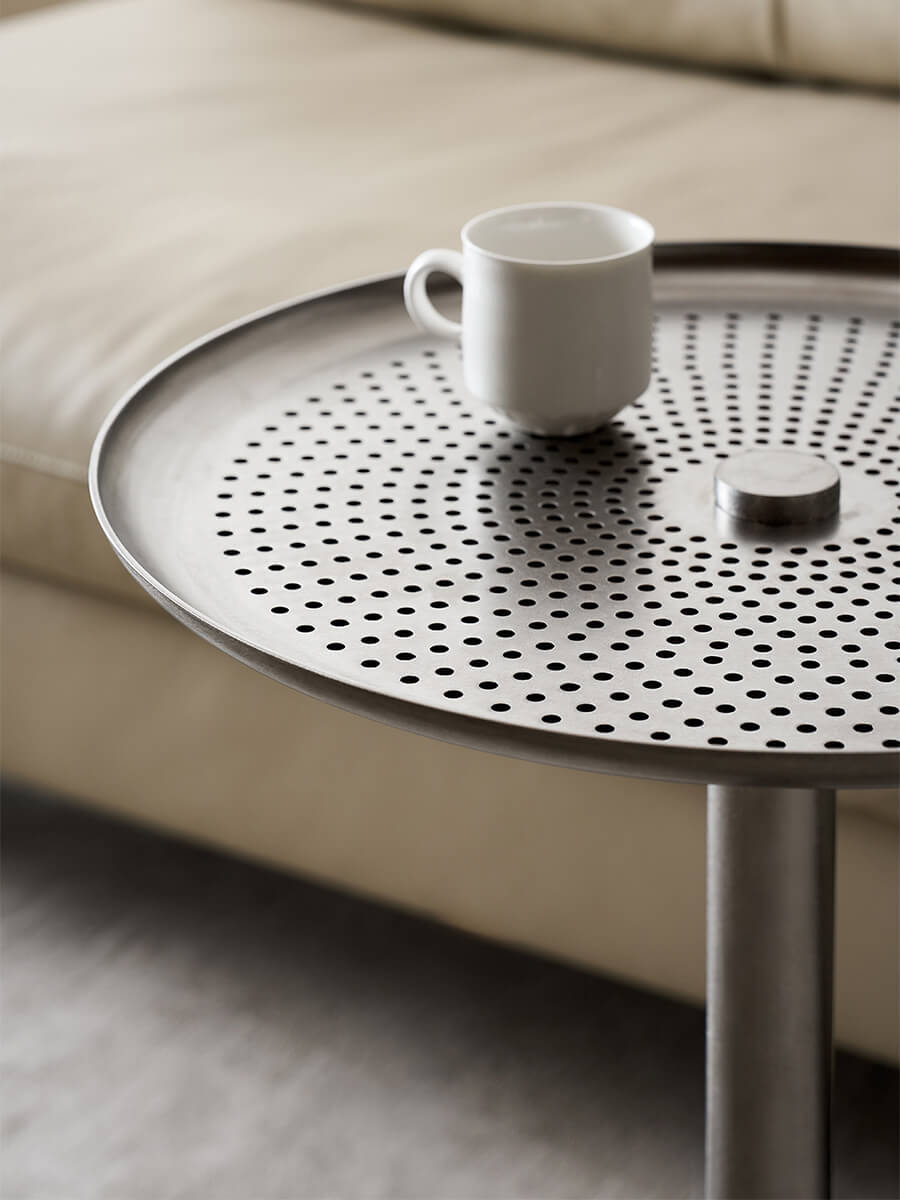 Sterling stainless steel side table showing perforated top and raised edge
