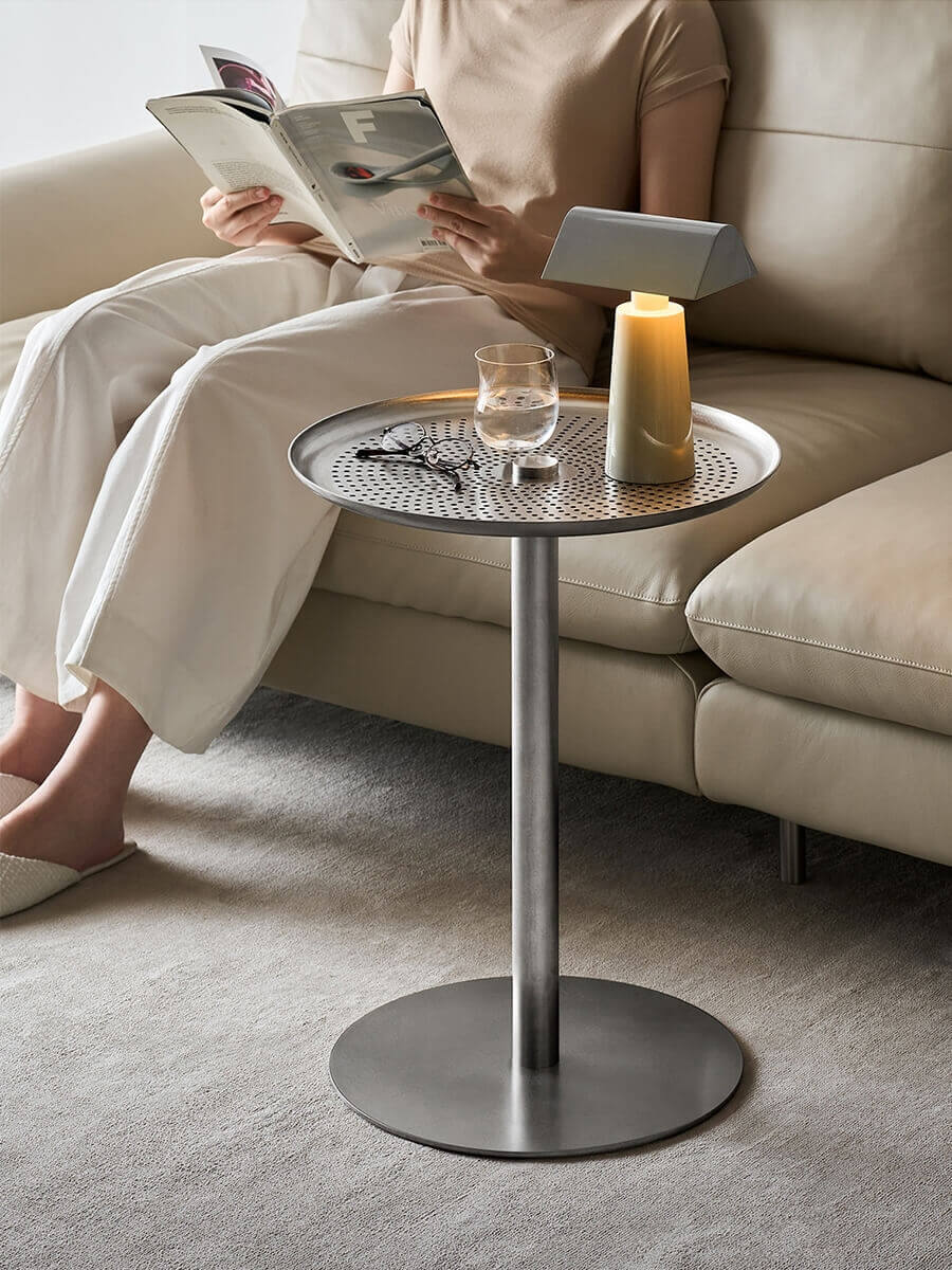 Sterling stainless steel side table beside a sofa