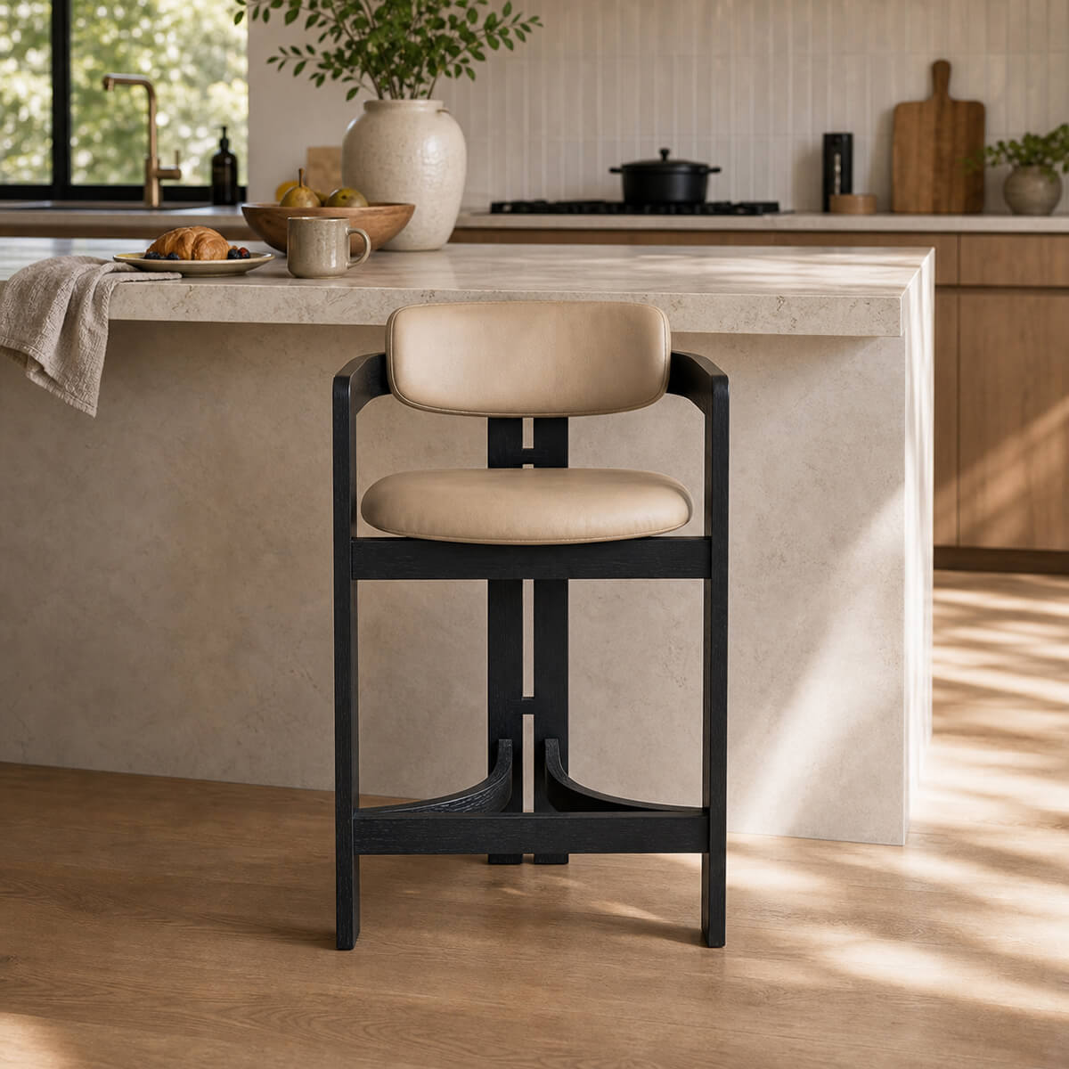 Tritt Bar Stool with black timber frame and beige upholstered seat in modern kitchen