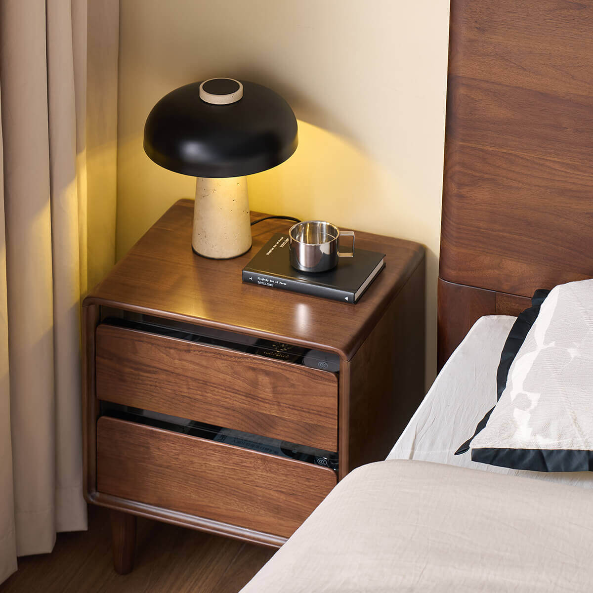 Tura solid walnut bedside table styled in a contemporary bedroom
