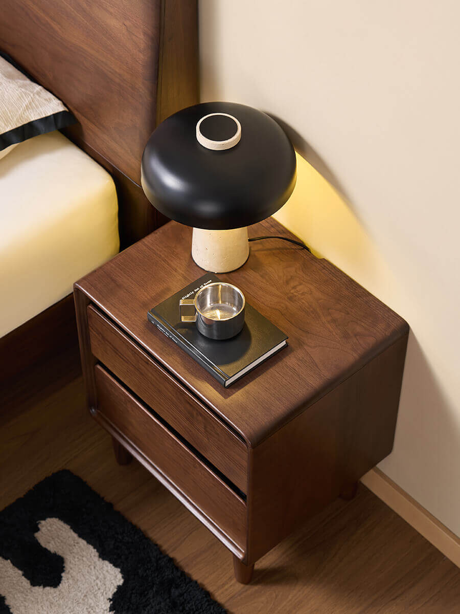 Top view of the Tura solid walnut bedside table showcasing the rounded timber design