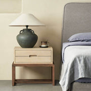 Venus timber bedside table beside a bed in a contemporary bedroom