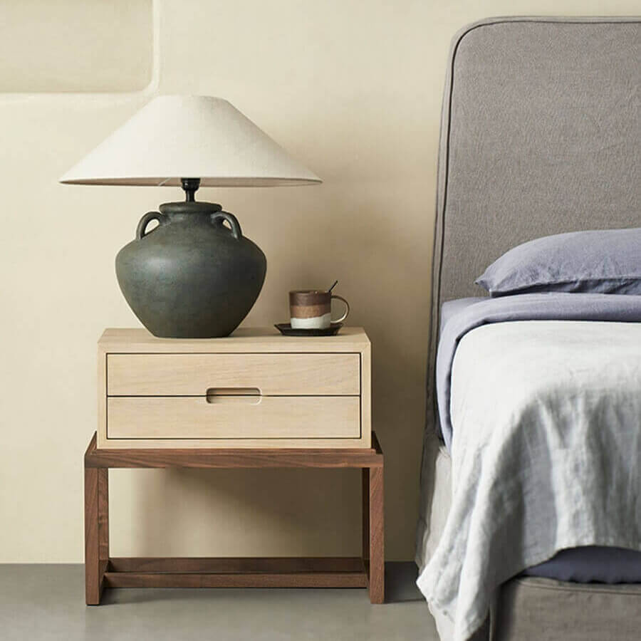 Venus timber bedside table beside a bed in a contemporary bedroom