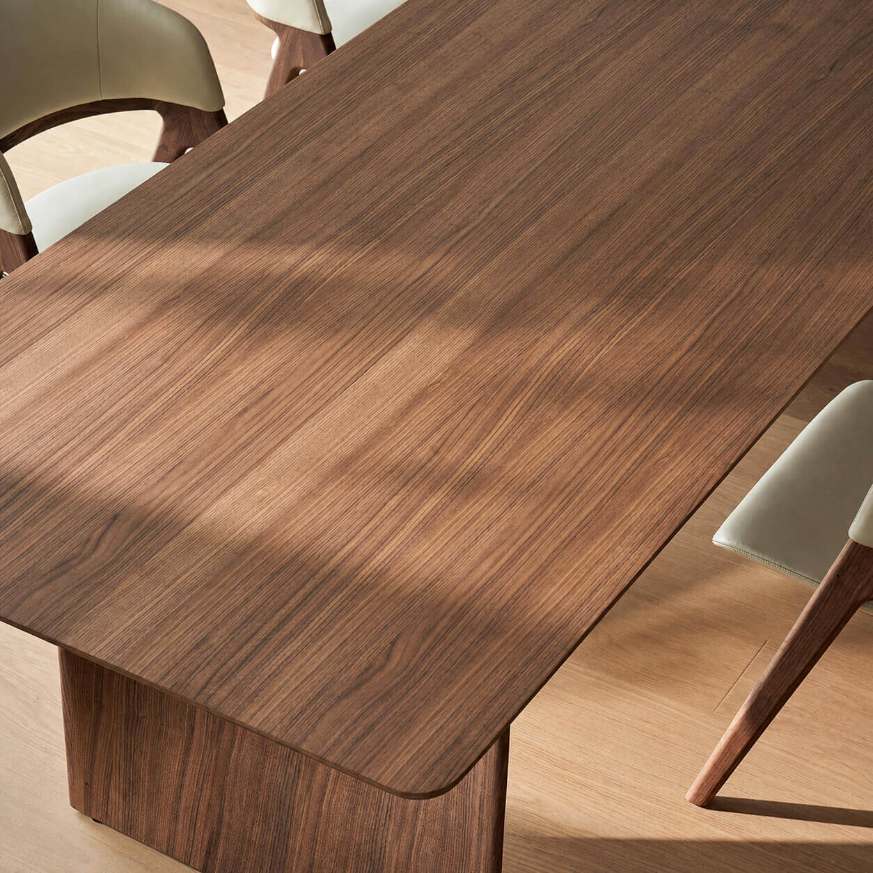 Vertex walnut veneer dining table with distinctive sculptural leg design