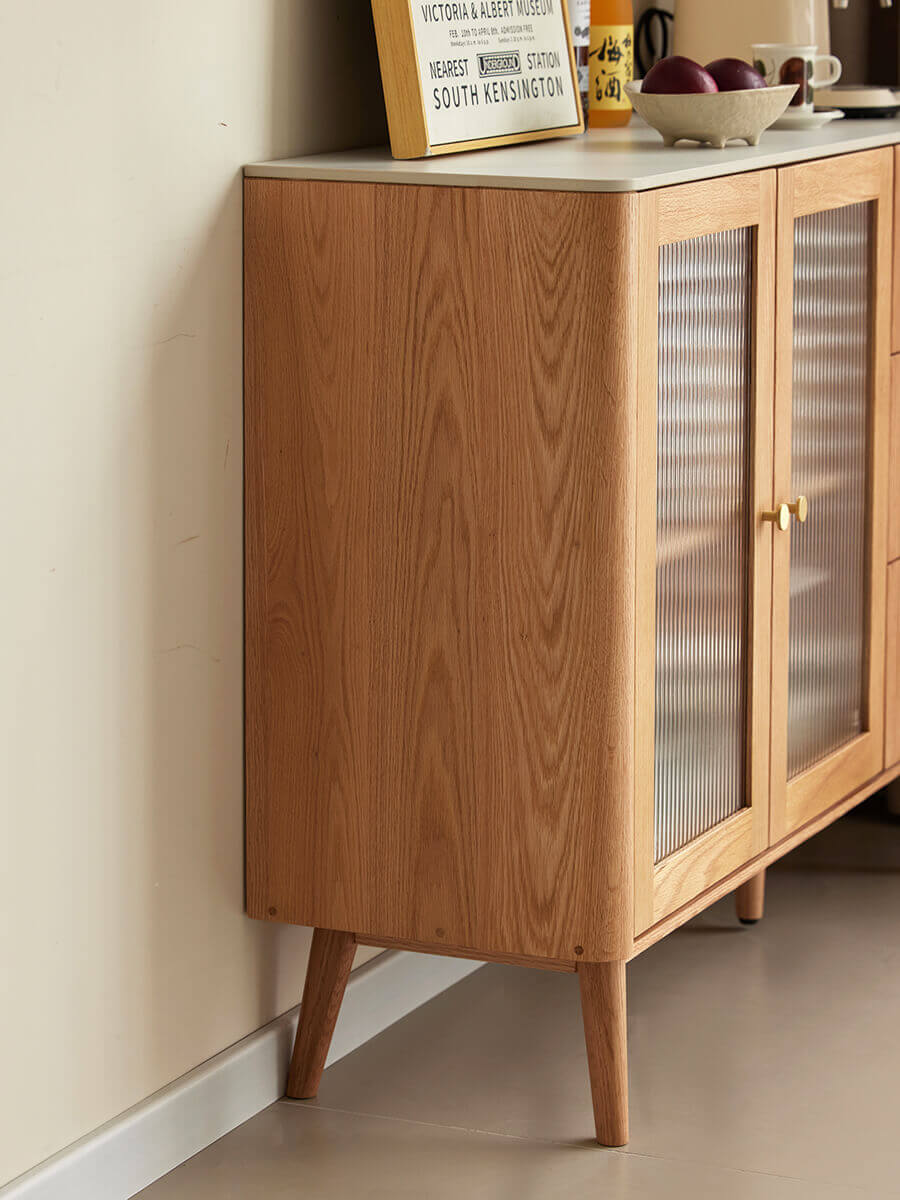 Side view of Voss solid oak sideboard showing the oak cabinet, sintered stone top and tapered legs.