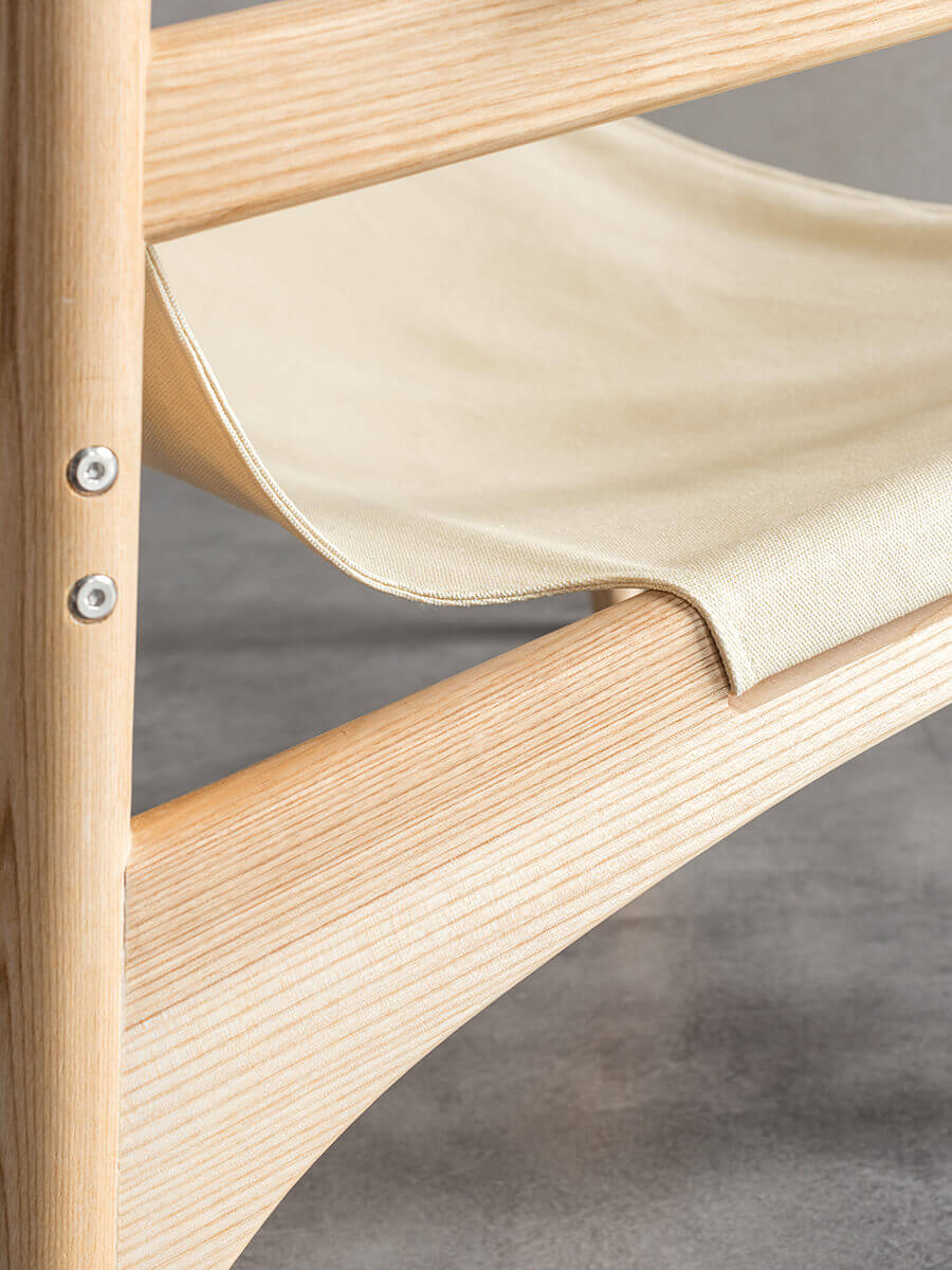 Close up detail of the Carey armchair canvas seat and timber frame