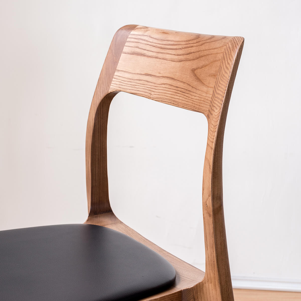 Curved timber backrest detail of the Visby dining chair