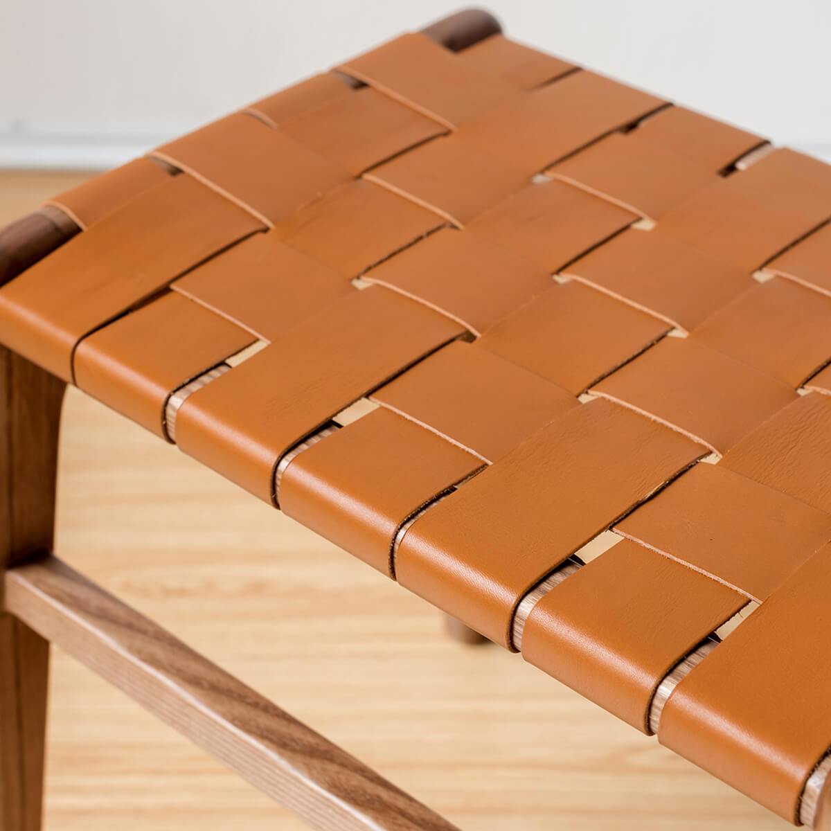 Close-up of the hand-woven saddle leather seat on the Connar stool