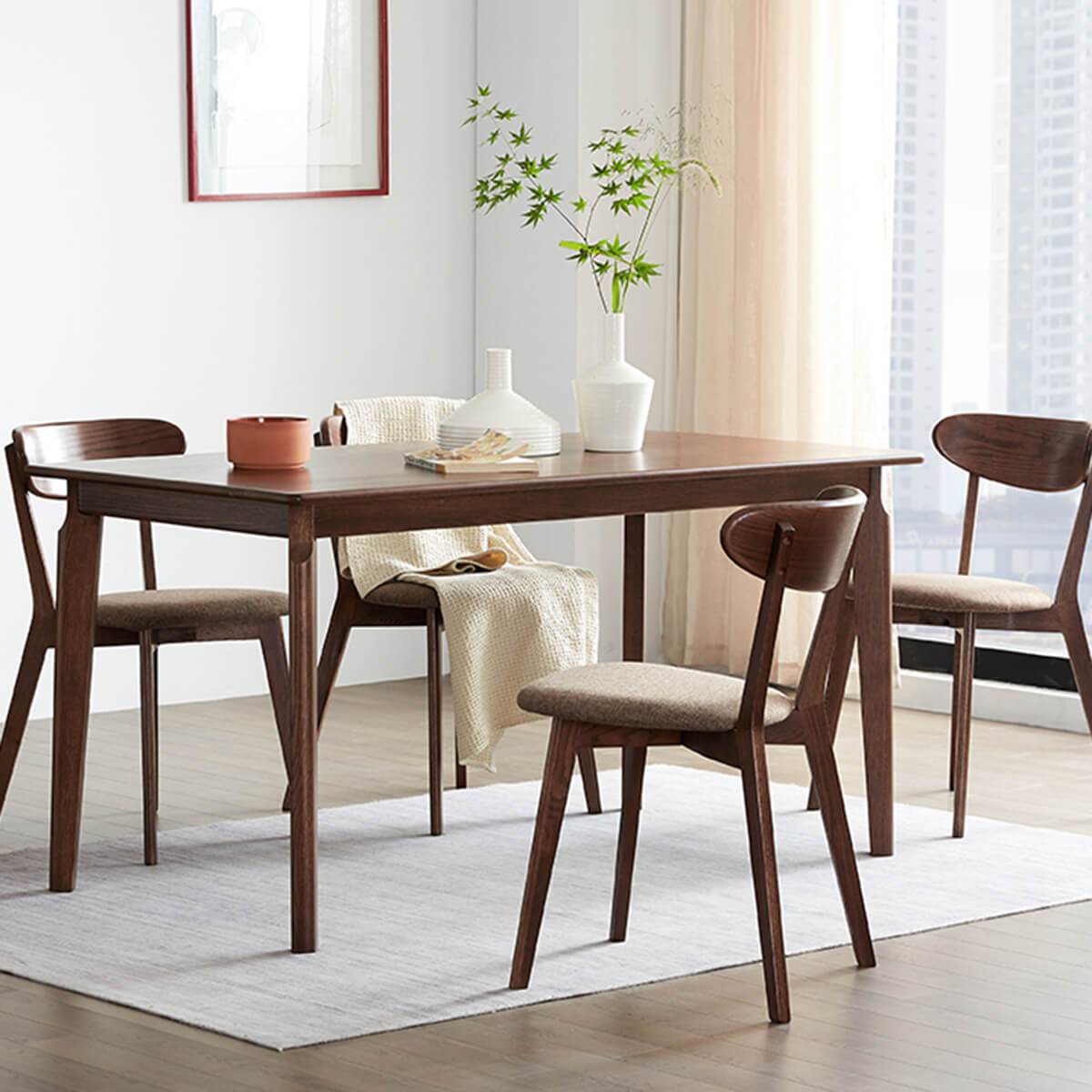 Denmark solid oak dining table in walnut finish styled in a modern dining room