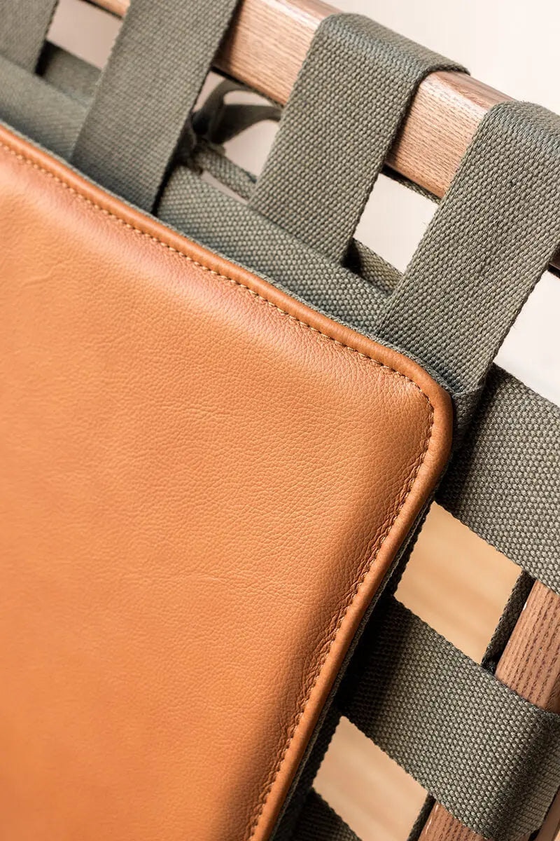 Close-up of the woven canvas suspension system on the Julian Armchair
