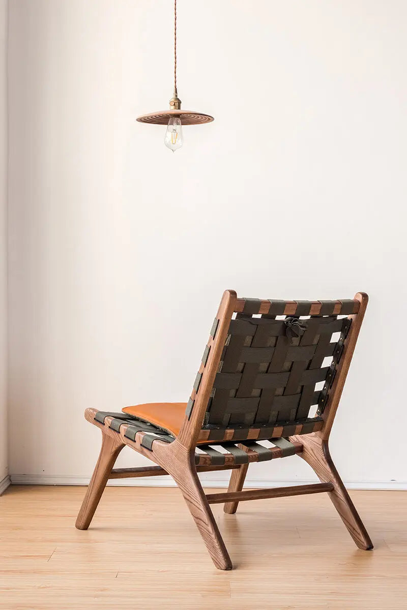 Rear angle view of the Julian Armchair highlighting the woven canvas backrest