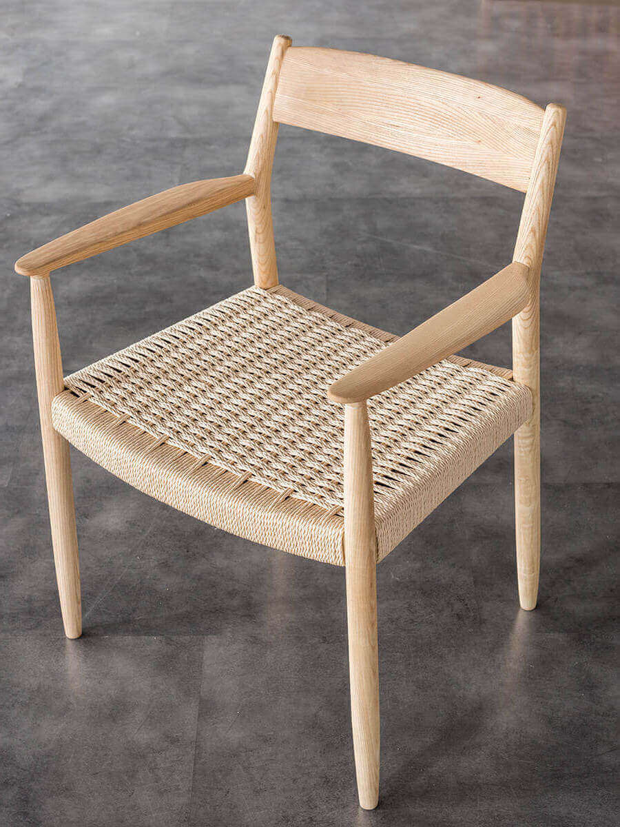 Angled view of the natural Lancer woven dining chair
