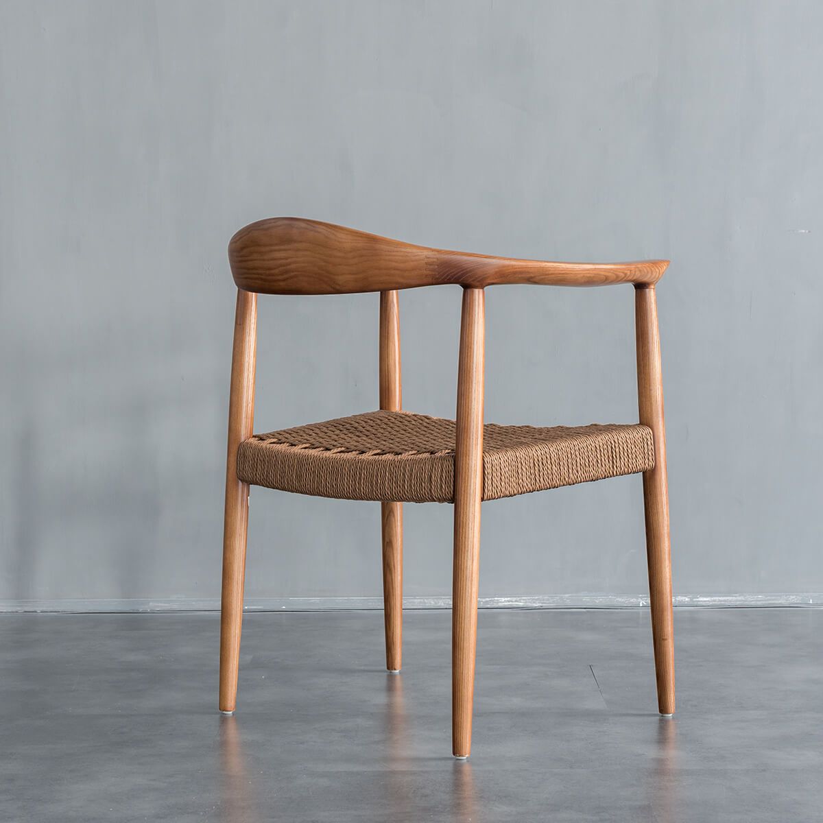 Side angle view of Lund solid ash dining chair with woven cord seat