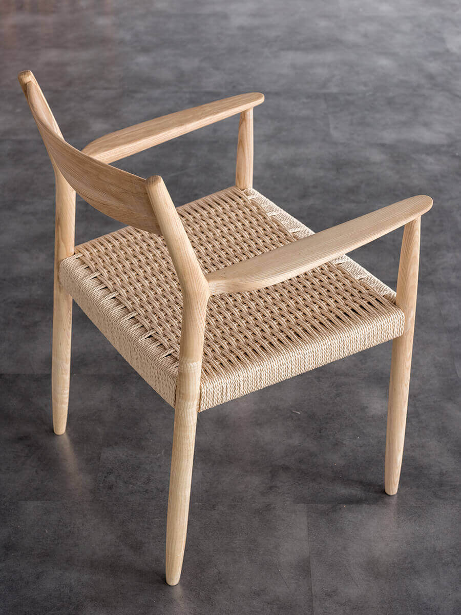 Rear angled view of the walnut Lancer woven dining chair